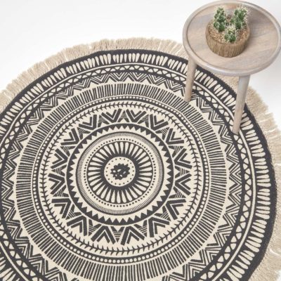 Black and White Mandala Rug with table and succulent.